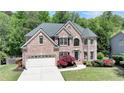 Charming two-story brick home with manicured lawn and beautiful landscaping at 1263 Whisperwood Ln, Lawrenceville, GA 30043