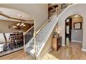 Spacious foyer with hardwood floors, staircase and view into the formal dining room at 1263 Whisperwood Ln, Lawrenceville, GA 30043