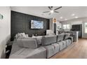 Open-concept living area with hardwood floors and accent wall at 137 White Mountain Pass, Mcdonough, GA 30252