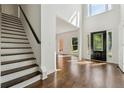 Elegant foyer with hardwood floors, staircase, and large windows allowing ample natural light at 2160 Waters Ferry Dr, Lawrenceville, GA 30043