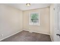 Bedroom with two windows featuring neutral colored walls and carpet flooring at 310 Oak Se Dr, Atlanta, GA 30354