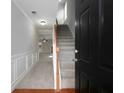 Inviting foyer featuring hardwood flooring, staircase, white wainscoting and an open floor plan at 415 Village Way, Woodstock, GA 30188