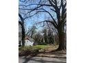 Sunny lot with large trees and partial grass cover, ready for new construction at 419 Lanier Nw St, Atlanta, GA 30318