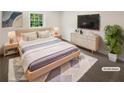 Comfortable staged bedroom with a bed, nightstands, dresser, TV and soft rug at 4357 Treeline Way, Douglasville, GA 30135