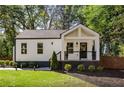Charming home featuring a covered front porch, manicured landscaping and a newly painted exterior at 1481 Almont Sw Dr, Atlanta, GA 30310