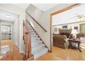 Warm and inviting foyer with hardwood floors and staircase at 1488 Rivermist Sw Dr, Lilburn, GA 30047