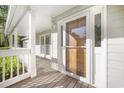 Inviting covered front porch with wood decking and white columns at 1488 Rivermist Sw Dr, Lilburn, GA 30047