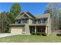 Inviting two-story home showcasing manicured landscaping and a classic facade at 158 Grove Meadow Dr, Acworth, GA 30101