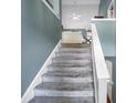 Carpeted staircase with white railing leading to the upper level of the home at 31 Churchill Downs Ne, Cartersville, GA 30121