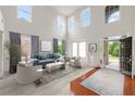Bright, open living room featuring high ceilings, large windows, and stylish decor at 5484 Stone Cove Sw Dr, Atlanta, GA 30331