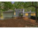 Charming home featuring a two-car garage, a landscaped yard and a wooded lot at 7320 Oak Arms Dr, Villa Rica, GA 30180