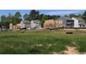 New home construction with framed houses, ready for customization in a green neighborhood at 1924 William Glen St, Dacula, GA 30019