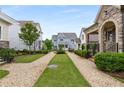 Beautiful home with well-maintained lawns, charming gravel walkways, and picturesque curb appeal at 2004 Haley Walk, Woodstock, GA 30188