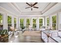 Bright sunroom features tray ceilings, wood floors, and ample natural light at 2355 Twelvestones Dr, Roswell, GA 30076