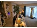 Cozy living room with neutral tones, plush seating, and a staircase leading to the upper level at 6193 Charring Cross Ct, Lithonia, GA 30058