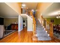 Spacious foyer with hardwood floors, staircase with wooden banister, and elegant column details, creating an inviting entrance at 2253 Carrington Dr, Ellenwood, GA 30294