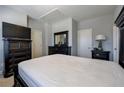Comfortable bedroom featuring a bed, black dresser, tv, and ample storage space at 2262 Haventree Ct, Lawrenceville, GA 30043