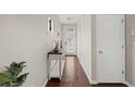 Inviting hallway featuring hardwood floors, neutral paint, and stylish console table at 5076 Longview Walk, Decatur, GA 30035