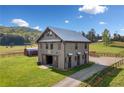 Custom barn home with a metal roof, wooden exterior and a large yard with a well-maintained driveway at 96 Landers Ne Rd, Rydal, GA 30171