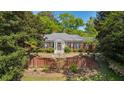 Elegant brick home with a classic facade, featuring a stately brick wall and lush landscaping at 289 W Paces Ferry Nw Rd, Atlanta, GA 30305