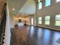 Expansive living space with hardwood floors, open layout, fireplace, and seamlessly connected to the kitchen at 3325 Linstead Ct, Loganville, GA 30052