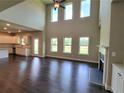 Spacious living room with hardwood floors, soaring ceilings, many windows, and an elegant fireplace at 3325 Linstead Ct, Loganville, GA 30052