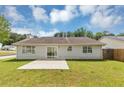 Spacious backyard featuring a concrete patio and lush green lawn at 1626 Cobbs Creek Ln, Decatur, GA 30032