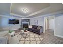Cozy living room with a stone fireplace, comfortable seating, and a modern entertainment center at 7580 Blacks Mill Rd, Cumming, GA 30028