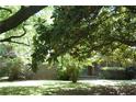 Traditional brick home with mature trees and a well-maintained lawn and landscaping at 5170 Chamblee Dunwoody Rd, Atlanta, GA 30338