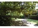 Classic brick home with a lush, green front yard and mature shade trees at 5170 Chamblee Dunwoody Rd, Atlanta, GA 30338