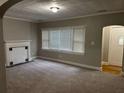 Inviting living room featuring neutral paint, new carpeting, a decorative fireplace, and ample natural light at 1297 Cahaba Dr, Atlanta, GA 30311