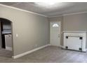 Cozy living room features fresh carpeting, a fireplace, and a doorway, offering a warm and welcoming atmosphere at 1297 Cahaba Dr, Atlanta, GA 30311