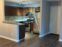 Cozy kitchen features granite countertops, stainless steel appliances, and a stylish backsplash at 4828 Westridge Dr, Norcross, GA 30093