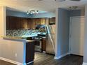 Cozy kitchen features granite countertops, stainless steel appliances, and a stylish backsplash at 4828 Westridge Dr, Norcross, GA 30093