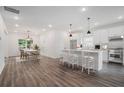 Spacious open-concept kitchen with stainless steel appliances and island with seating that flows into the dining area at 551 Lake Dr, Atlanta, GA 30354
