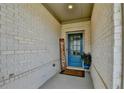Charming front entry with a bright blue door, 'welcome' sign, and potted plants at 5650 Bergeson Ways, Cumming, GA 30028