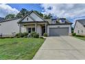 Inviting home exterior with a well-manicured lawn and neutral color palette at 5650 Bergeson Ways, Cumming, GA 30028