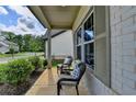 Relaxing front porch area with comfortable seating and attractive brick facade at 5650 Bergeson Ways, Cumming, GA 30028
