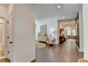 Hallway featuring wood floors and contemporary decor leading to living spaces at 5650 Bergeson Ways, Cumming, GA 30028
