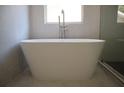 Elegant standalone bathtub with modern fixtures, set against a serene window view, creating a relaxing oasis at 70 Gardenia Nw Dr, Atlanta, GA 30314