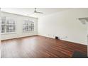 Bright living room with hardwood floors, a ceiling fan, and large windows that let in natural light at 3505 Chattahoochee Summit Se Ln # 25, Atlanta, GA 30339