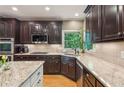 Well-equipped kitchen with granite countertops, custom cabinets, and stainless steel appliances at 6795 Preston Glen Dr, Alpharetta, GA 30005