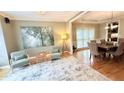 Inviting living room with hardwood floors, tray ceiling, large windows, and a comfortable seating arrangement at 6795 Preston Glen Dr, Alpharetta, GA 30005