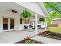 Inviting covered porch with outdoor seating and ceiling fans, perfect for relaxing outdoors at 5766 Macland Rd, Powder Springs, GA 30127