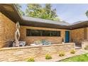 Charming brick home with an outdoor sitting area, stone wall, and unique architectural details at 639 W Ponce De Leon Ave, Decatur, GA 30030