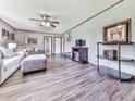 Spacious living area with ceiling fan, wainscoting, and wood-look flooring at 72 Hazelwood Nw Rd, Cartersville, GA 30121
