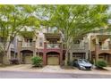 Charming townhome with brick accents, covered porch, and attached garage at 863 Commonwealth Se Ave, Atlanta, GA 30312