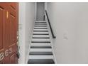 Entryway staircase with freshly painted white risers, black treads, and a sleek handrail at 863 Commonwealth Se Ave, Atlanta, GA 30312