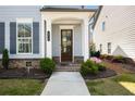 Inviting front porch with a dark wood door, white columns, and manicured landscaping, enhancing curb appeal at 2316 Echelon Ln, Smyrna, GA 30080