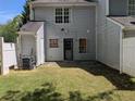 Small backyard with light blue siding, a door, and a small patio at 3789 Waldrop Ln, Decatur, GA 30034